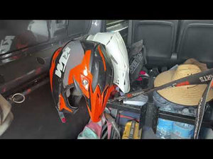 L-track helmet holder for motovan and trailer